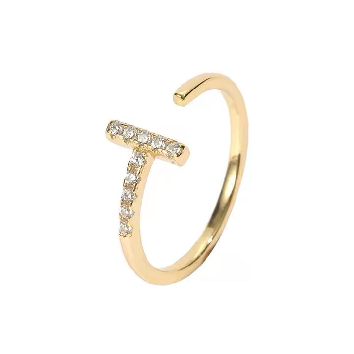 Gold open ring with embedded diamonds on a white background