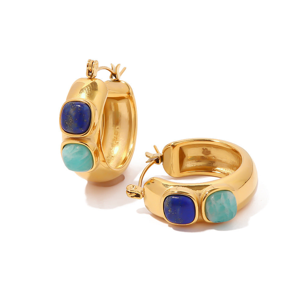 Gold hoop earrings with blue and green stones on a white background