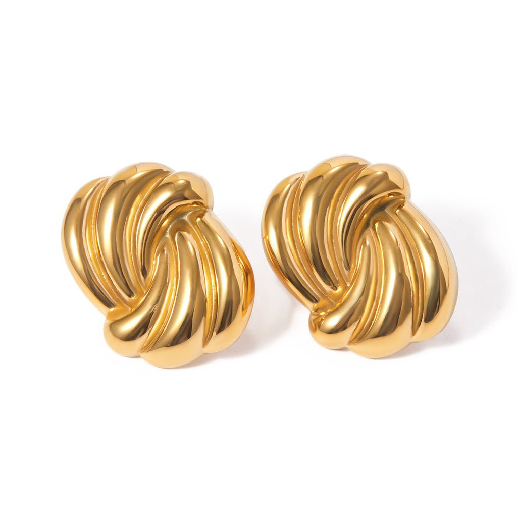 Pair of gold knot earrings on a white background